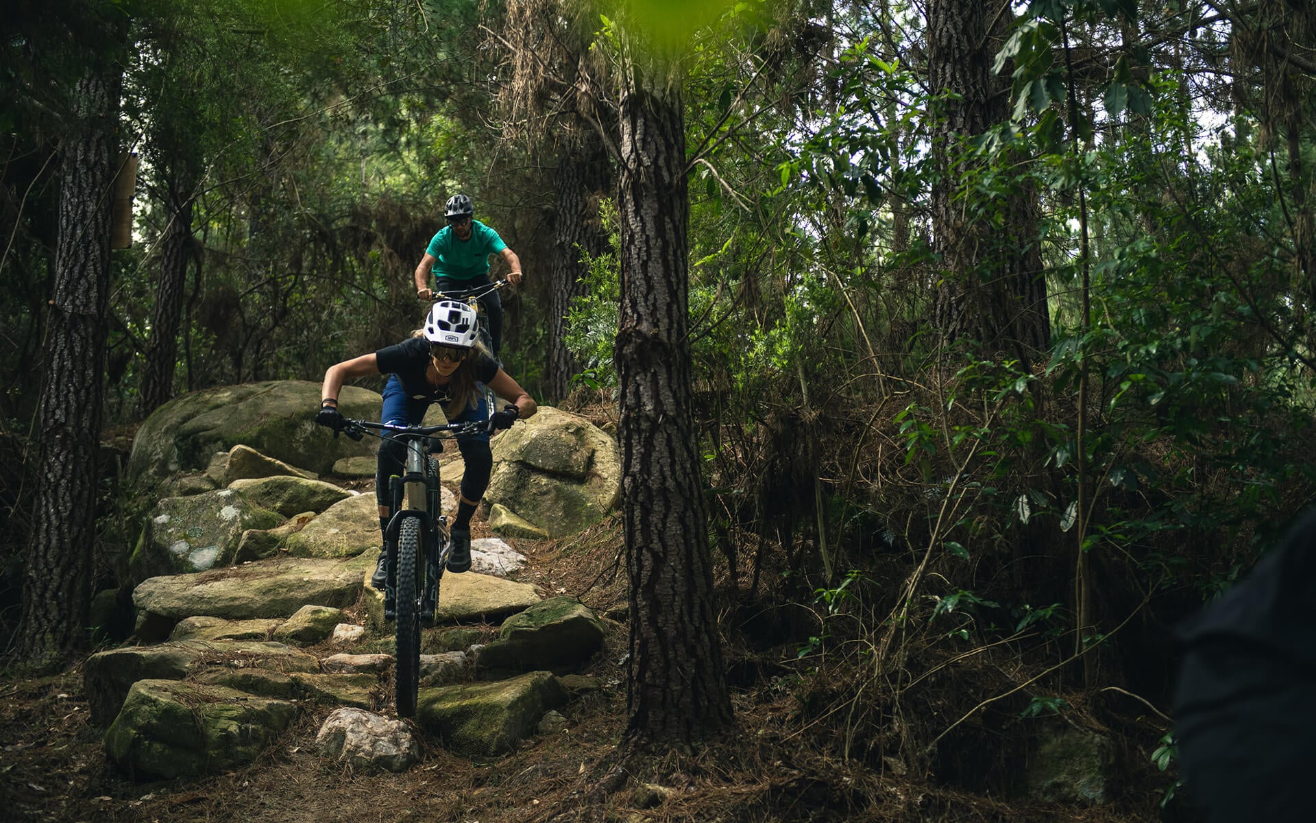 Joe follows Rae through the rock garden at Kaiteriteri MTB Park.