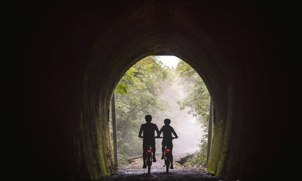 Spooners Tunnel is a standout section of the Great Taste Trail, offering a unique ride through railway history.