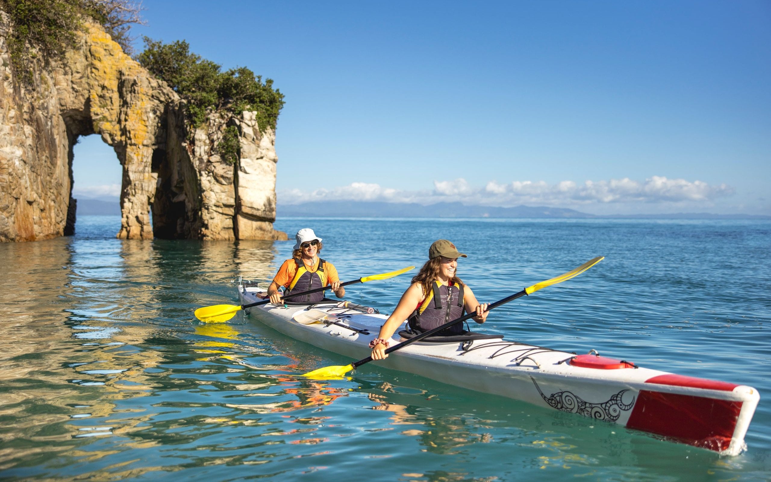 Explore hidden archways and calm turquoise waters with Golden Bay Kayaks.