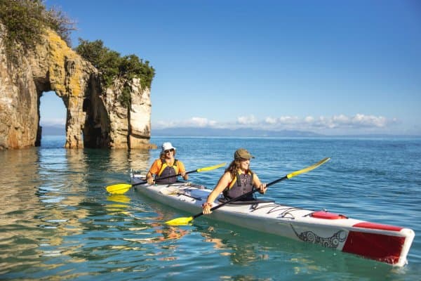 Explore hidden archways and calm turquoise waters with Golden Bay Kayaks.