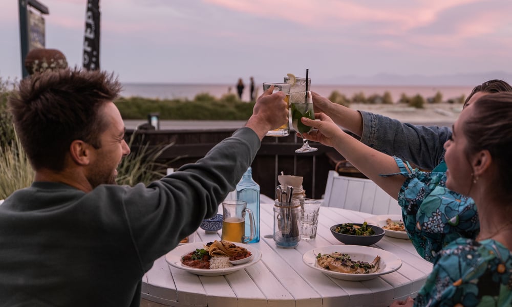 Tuck into fresh, local seafood at Hooked on Mārahau, a relaxed beachfront eatery with unbeatable views of the Abel Tasman coastline.
