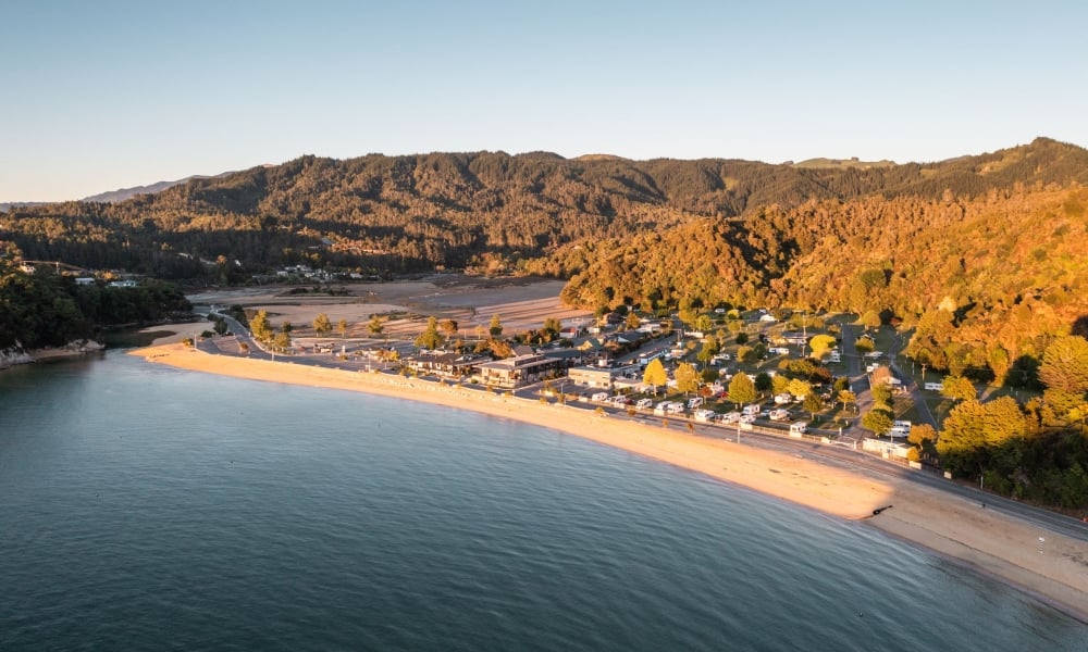 Soak up the sun at Kaiteriteri Beach, where golden sands and crystal-clear waters mark the gateway to Abel Tasman National Park.