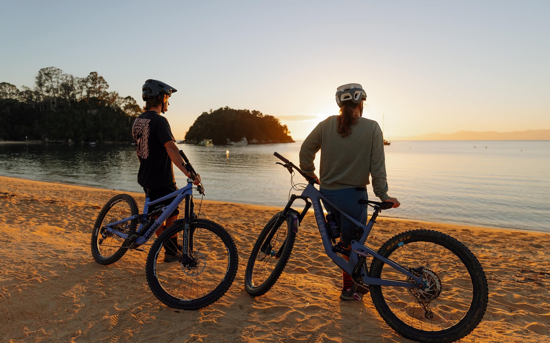 Couple Sunset Mountain Biking Kaiteretere credit Henry Jaine