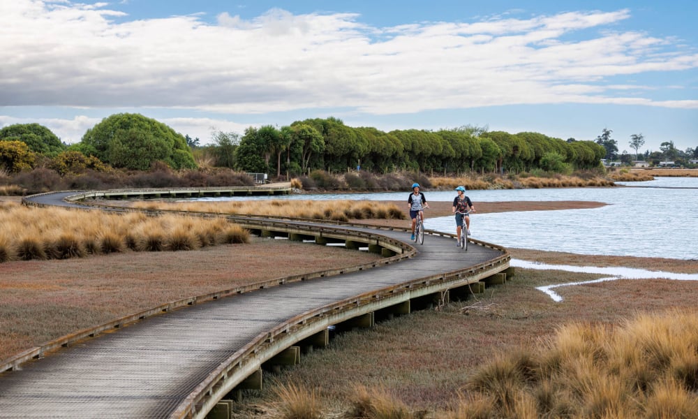 Cruise the trails around Waimea Inlet for a laid-back ride with epic coastal views.