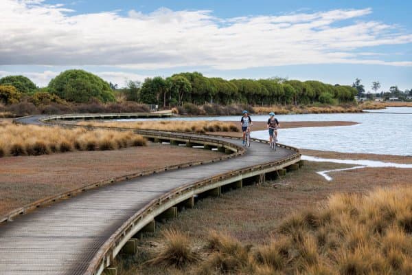 Cruise the trails around Waimea Inlet for a laid-back ride with epic coastal views.