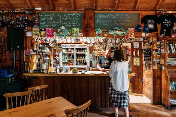 The Mussel Inn is a rustic, beloved spot known for its craft beers, live music, and laid-back vibe, nestled in the heart of Golden Bay.